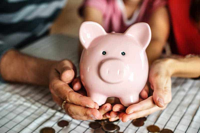 saving money using a piggy bank