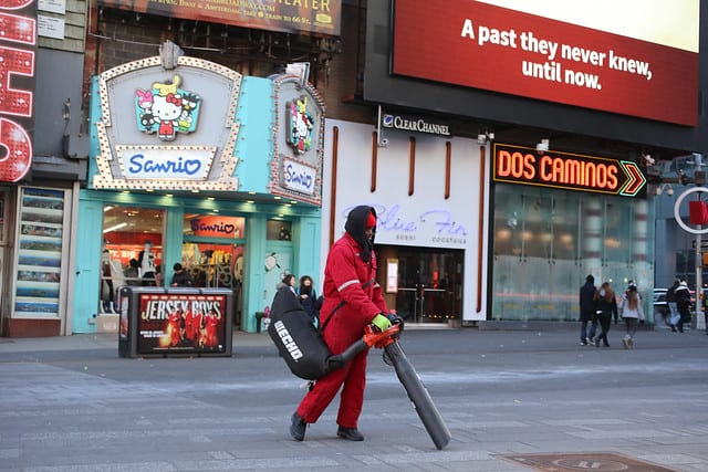 Times Square workers with large vacuum cleaners in the square.