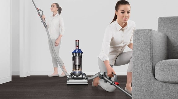 women vacuuming the area