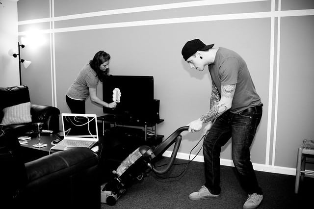 greyscale of couple cleaning the room