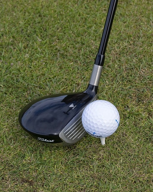 golf club positioned to hit the golf ball