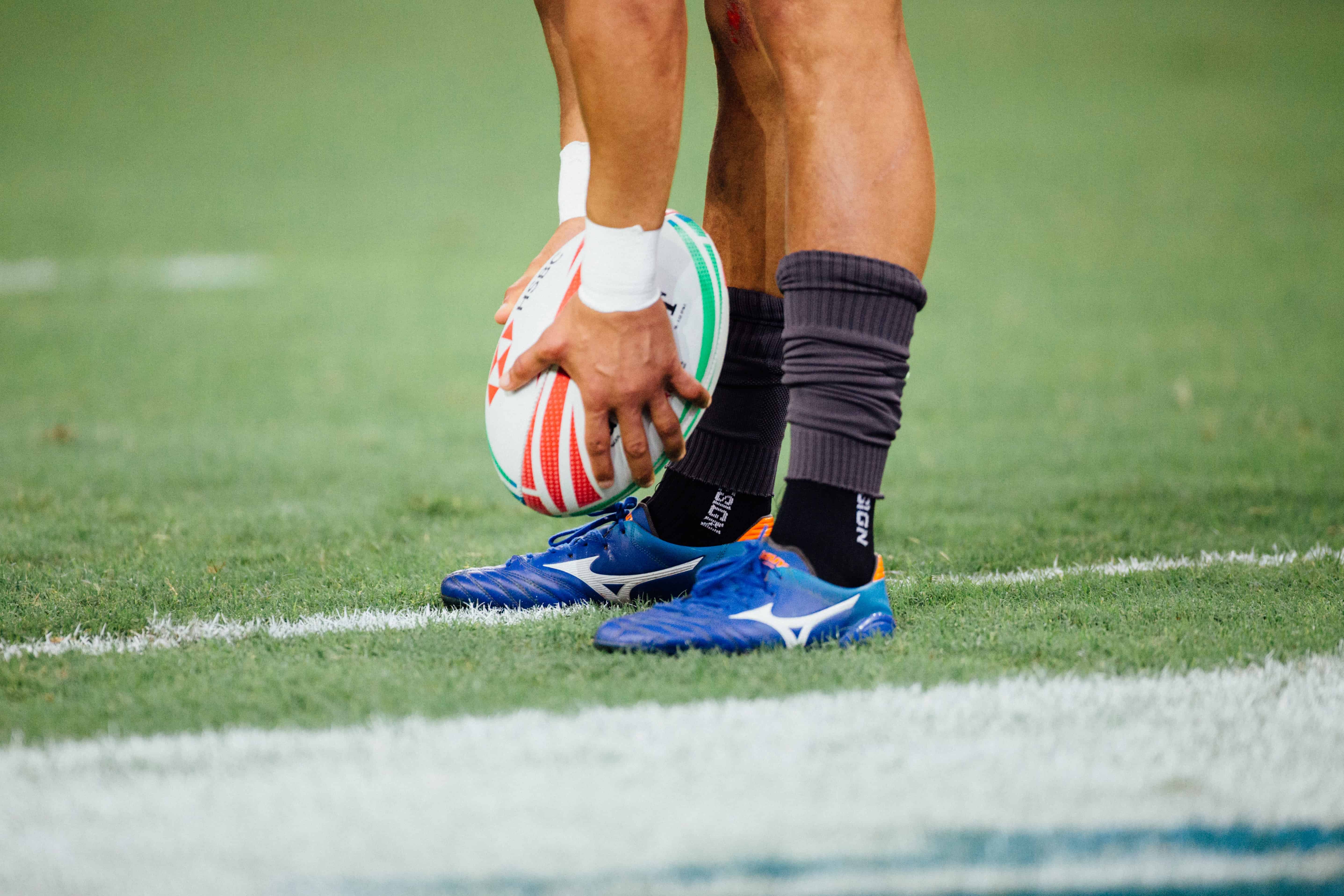 a rugby player putting the ball down