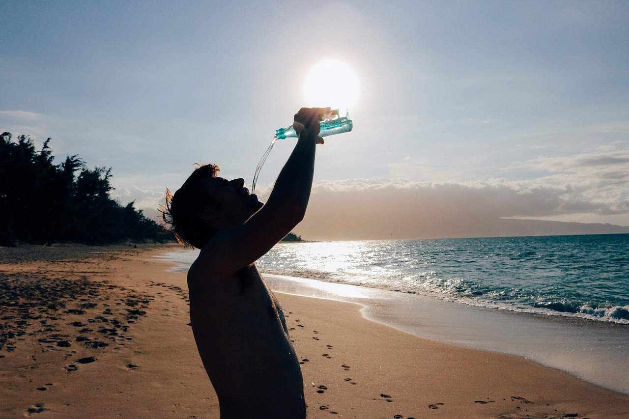 man drinking water using - best glass water bottle glass water bottle 