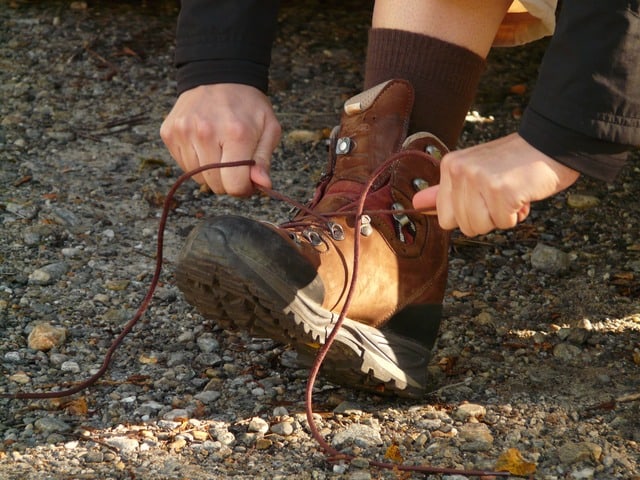 a man tying the lace of his boots